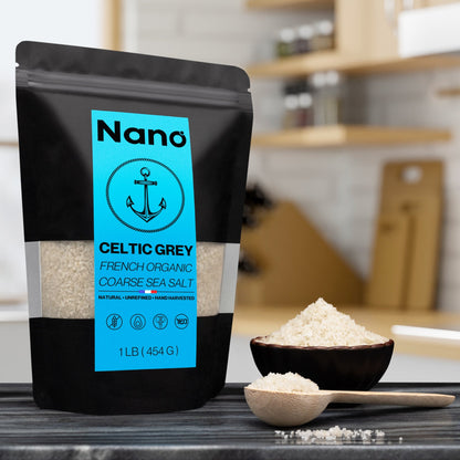 1 LB bag of Nano Celtic Grey French Organic Coarse Sea Salt sitting on a marble countertop in a bright modern kitchen