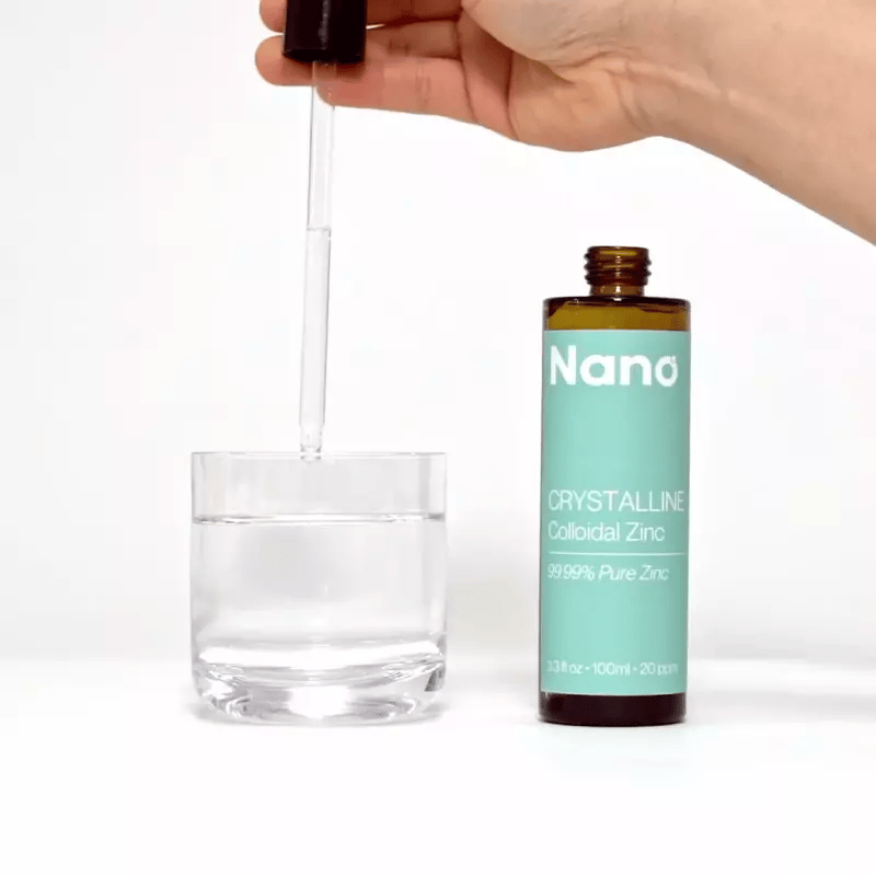 Mixing a few drops of Nano colloidal liquid zinc into a glass of water